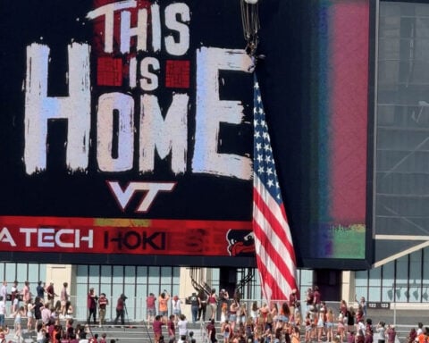 Football-Skydiver left dangling when parachute snags on stadium video board