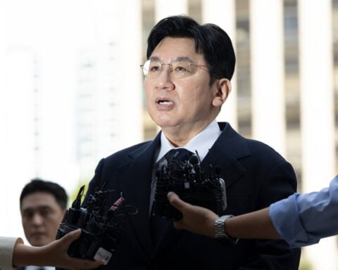 South Korean police seek to arrest K-pop mogul behind BTS