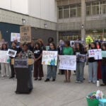 Community members rally against proposed budget cuts to arts and libraries