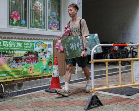 Back home, Hong Kong fire victim gathers memories from the ashes