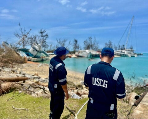 Searchers find the body of 1 of 6 missing crew from a ship that overturned during a typhoon