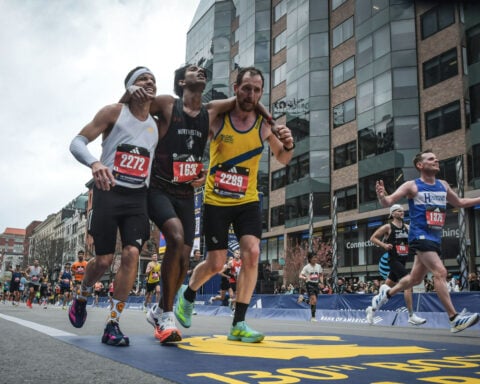 Runners were struggling to finish Boston Marathon when competitors came along and helped them across