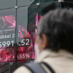 Asian stocks retreat and oil tops $100 despite fresh records on Wall St