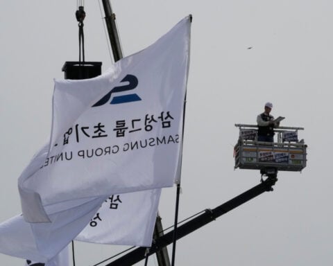Samsung workers rally in South Korea, demanding higher pay and threatening to strike