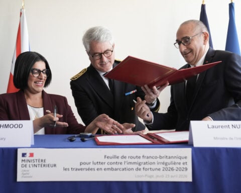 UK and French governments sign a 3-year deal to curb migrant crossings in English Channel