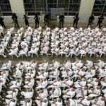 In El Salvador, shackled prisoners watch their mass trial on a big screen