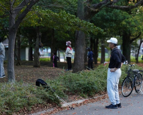 Japan awakens to Radio Taiso exercise tradition. One face of the country's longevity