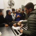 Palestinians hold funerals for pregnant woman and her children killed in Israeli strikes