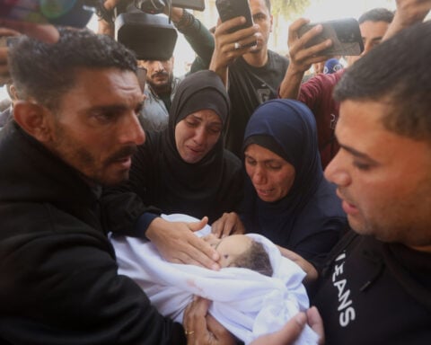 Palestinians hold funerals for pregnant woman and her children killed in Israeli strikes