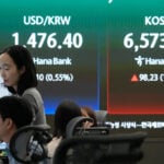 Asian shares are mixed and oil gains more than $1 as Iran talks remain in flux