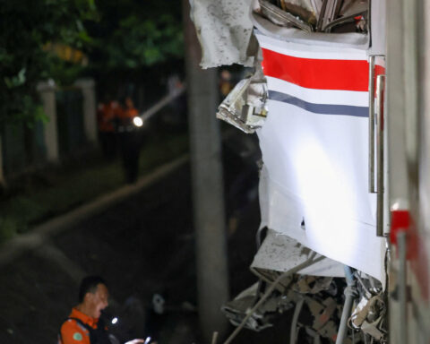Indonesia train crash toll rises to 14 as rescuers work to remove trapped passengers