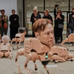 Robot dogs with Musk and Zuckerberg heads roam around Berlin gallery in Beeple's new exhibit