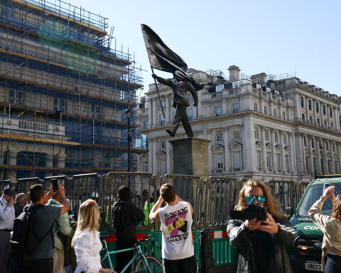 London hails new Banksy statue of man blinded by flag