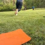 Police and firefighters play kickball with foster children to build trust