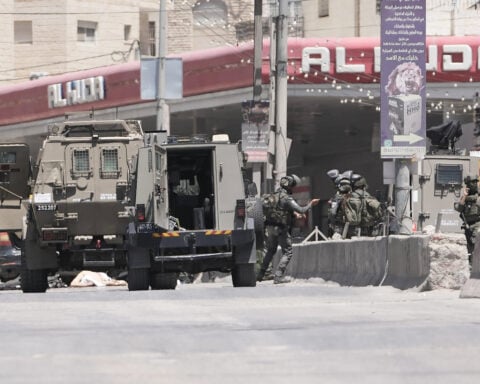 Israel's military said a Palestinian family could bury their father. Then the settlers arrived