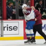 MacKinnon takes a puck from an Avs teammate to the face