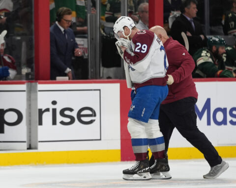 MacKinnon takes a puck from an Avs teammate to the face