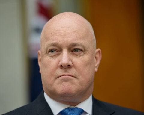 NZ trims new spending, sticks to surplus path as global risks heighten