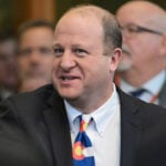 Colorado's Democratic governor commutes ex-election clerk Tina Peters' sentence after Trump pressure