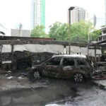 A cargo train hits a public bus at a Bangkok rail crossing, killing at least 8