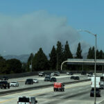 Fast-growing brush fire in Southern California threatens homes