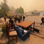 Fast-growing brush fire in Southern California threatens homes