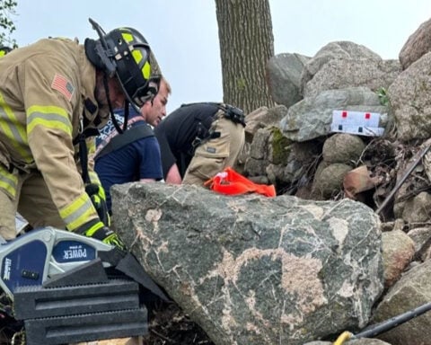 Firefighters free woman pinned by large stone