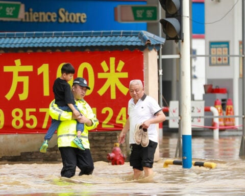 Torrential rain and floods batter China, killing at least 12 and forcing mass evacuations