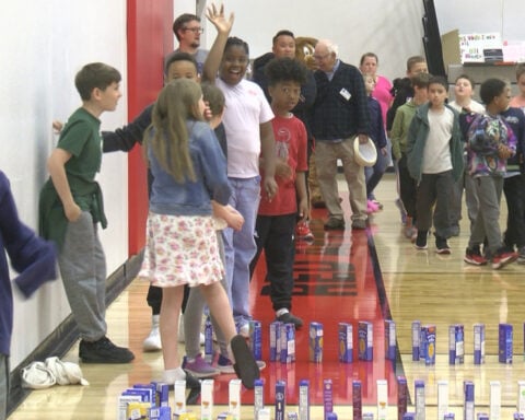 Students create mac-and-cheese domino train before making donation to community