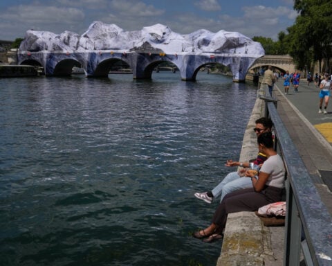Artist JR, the 'French Banksy' creates a 'cave' installation over Paris' oldest bridge