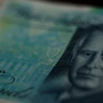 Pound softens as UK consumers cut spending, public finances worsen