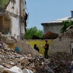Forensic experts sift through ruined dormitory in Russian-held Luhansk region
