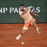 Novak Djokovic overcomes a slow start and hostile crowd in 1st-round win at French Open