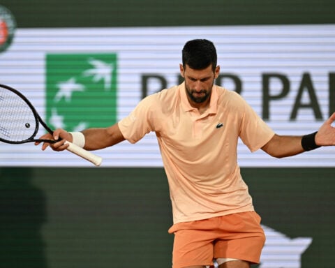 Novak Djokovic overcomes a slow start and hostile crowd in 1st-round win at French Open