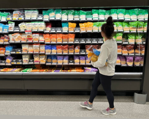 As US stock market hits new highs, 2 of 3 Americans are cutting back on spending, survey shows