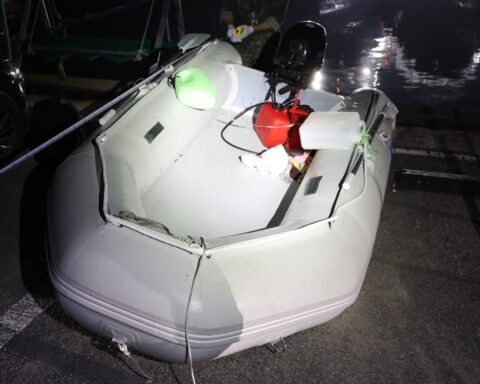 A Chinese dissident is in South Korean custody after a perilous escape by rubber boat