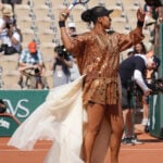 Naomi Osaka's latest French Open fashion ensemble includes an ivory train and gold jacket
