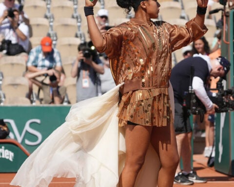 Naomi Osaka's latest French Open fashion ensemble includes an ivory train and gold jacket