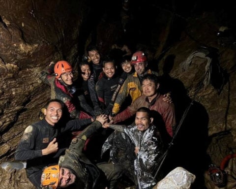 Rescuers pull first trapped person from flooded Laos cave