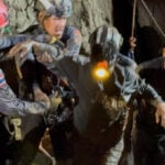 Rescuers work to free 4 men who remain trapped in flooded Laos cave and search for 2 still missing