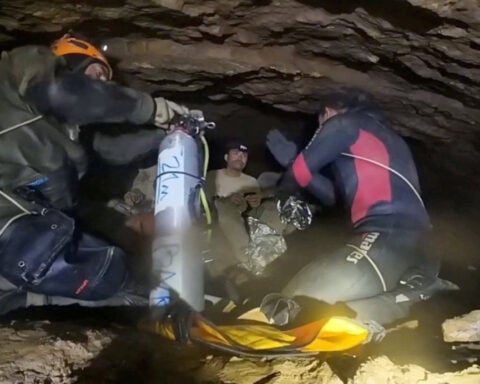Rescuers pull four from flooded cave in Laos, two still missing