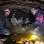 Rescuers free 4 men who had been trapped in a flooded Laos cave, search for 2 still missing