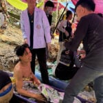 Rescuers free 4 men who had been trapped in a flooded Laos cave, search for 2 still missing