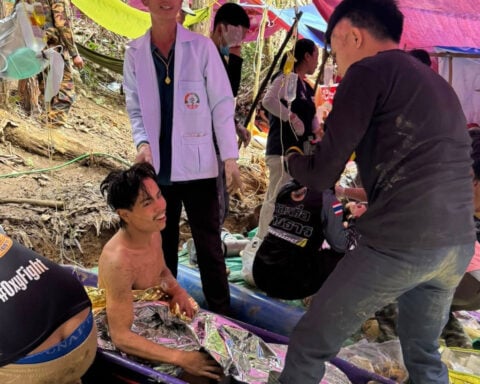 Rescuers free 4 men who had been trapped in a flooded Laos cave, search for 2 still missing