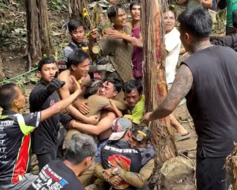 Rescue divers react after trapped villagers free themselves from Laos cave
