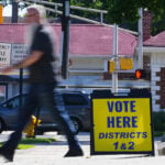 The Latest: Polls open for races across the US as a busy primary election day gets underway