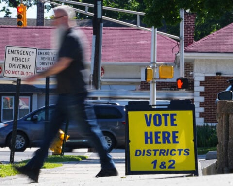 The Latest: Polls open for races across the US as a busy primary election day gets underway