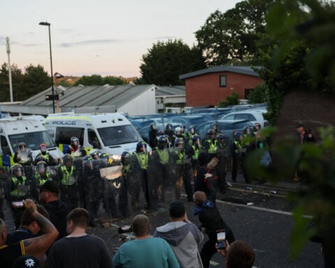 UK interior minister condemns violent reaction to handcuffed student's death