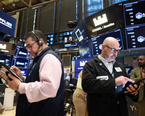 Dow claims record closing high, S&P 500 advances; chip selloff weighs on Nasdaq