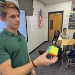 High School senior uses Rubik's cube skills to teach 8th graders math